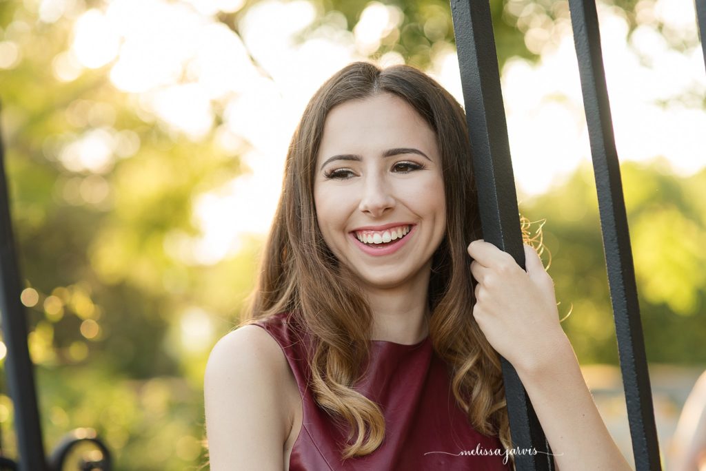 senior girl from shadyside pa stands against an iron gate for senior portrait session in Pittsburgh PA